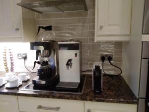 a coffee maker on a counter in a kitchen at Chine Side in Shanklin