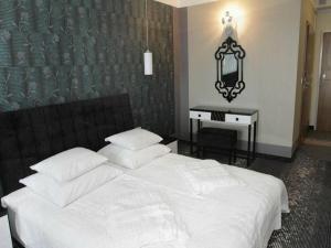 Łóżko lub łóżka w pokoju w obiekcie Hotel Europa