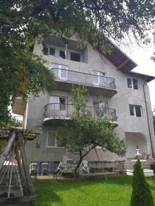 a building with balconies on the side of it at Vila Elena si Ionut in Breaza
