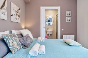 a bedroom with a blue bed with towels on it at Pure Pool Sensation Apartment Sitges in Sitges +19 photos