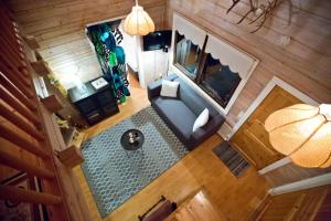 an overhead view of a living room with a blue couch at Lake Kesänki Cottage in Äkäslompolo
