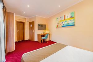 a hotel room with a bed and a desk at BUCUR 9 Boutique Hotel in Bucharest