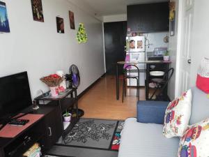 a living room with a couch and a kitchen at The Escape Pad 1 by Sharon May in Manila +5 photos