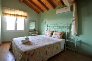 a bedroom with a bed with a teddy bear on it at Villa Theodora View Apartments Zeys in Agios Georgios Pagon