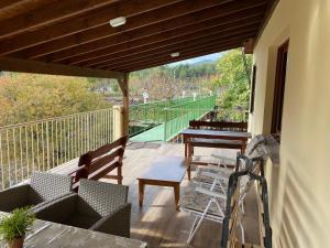 a patio with chairs and a table on a balcony at SZ Guesthouse in Trimiklini