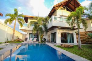 a villa with a swimming pool in front of a house at Resona Pool Villa in Ao Nam Mao