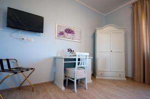 a room with a desk and a television on the wall at B&B La Madonnina in Montefalco