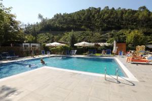 a large swimming pool with people in it at Villaggio Camping Valdeiva in Deiva Marina