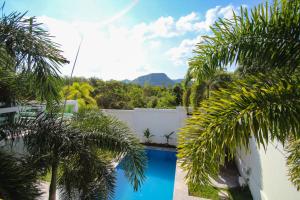 a swimming pool in a yard with palm trees at Resona Pool Villa by Aonanta Group in Ao Nam Mao