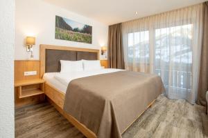 Кровать или кровати в номере OLYMPIA Privathotel Garni