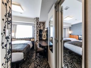 Postel nebo postele na pokoji v ubytování APA Hotel & Resort Midosuji Hommachi Eki Tower