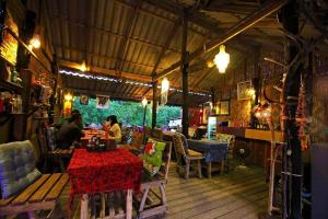 a restaurant with people sitting at a table at PP Red Tuna Hut in Phi Phi Don