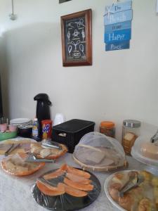 a table topped with plates of food on a counter at Mar & Mar Suites in Arraial do Cabo +30 photos