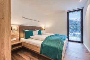 Postel nebo postele na pokoji v ubytování Alpin Apart Montafon
