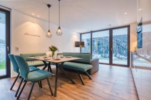 a dining room with a table and chairs at Alpin Apart Montafon in Sankt Gallenkirch