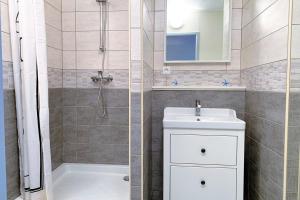 a bathroom with a shower and a sink and a mirror at A l'Ancre Bleue in Le Tréport +16 photos