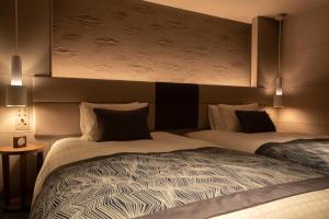 Tempat tidur dalam kamar di Tokyu Stay Kyoto Sakaiza Shijo Kawaramachi