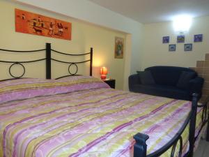 a bedroom with a bed and a chair at Antico Borgo in Castiglione di Sicilia