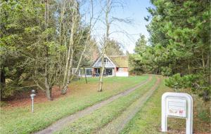 a road in front of a house with a sign at Holiday Home Lejrbjergvej Rømø X in Rømø Kirkeby +12 photos