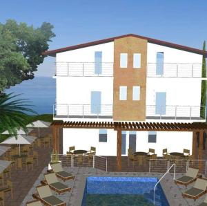 a building with chairs and a swimming pool next to a building at The Brothers Villa Hotel in Ohrid