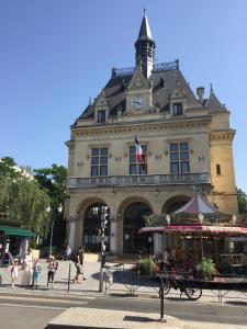 a building with a clock tower on top of it at PEH ancienne version in Bagnolet