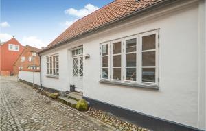 a white house with windows on the side of a street at 3 Bedroom Cozy Home In Tnder in Tønder