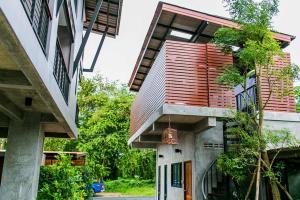 an external view of a house with a bell hanging from it at Palmari Boutique Hotel in Ban Nua Khlong