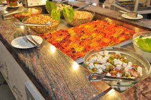 a buffet line with many different types of food at Mastichari Bay Hotel in Mastihari