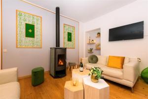 a living room with a couch and a fireplace at Zythogite Appartement 9 personnes, jardin, bbq in Tintigny