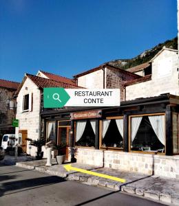 a building with a sign for a restaurant at Apartment Mediterraneo Blue Sky in Perast