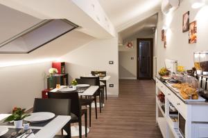 a restaurant with tables and chairs and a buffet at Etna Sunrise b&b in Zafferana Etnea