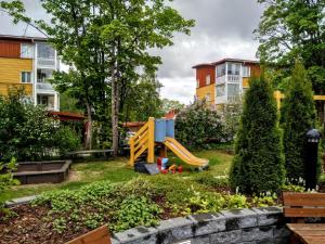 a playground with a slide in a park at Pinjakoti in Lahti