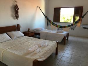 A bed or beds in a room at Beach House Paracuru B&B - cama e café
