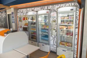 two refrigerators in a store with food and drinks at ibis budget Blumenau in Blumenau