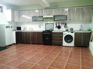 a kitchen with a dishwasher and a washer and dryer at Naqqosh in Khiva