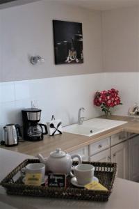 a kitchen with a counter with cups and a sink at Dreams & Love in Sarlat 1 et 2 in Sarlat-la-Canéda