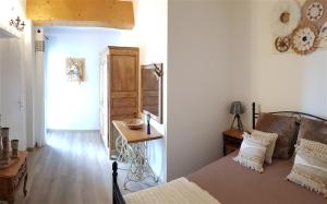 a bedroom with a bed and a table and a mirror at Villa T3 Jacuzzi 10' Plage Cassis - Rando Garlaban in Carnoux +15 photos