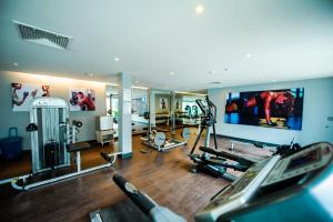 a gym with several treadmills and machines in a room at Hotel Selection Pattaya in Pattaya