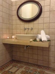 a bathroom with a sink and a mirror at Verdi Apartment in Castellammare del Golfo