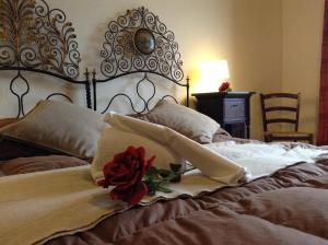 a bed with a rose sitting on top of it at Verdi Apartment in Castellammare del Golfo