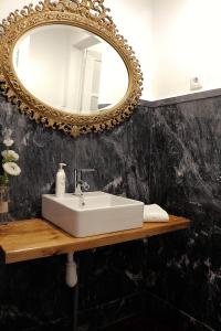 a bathroom with a white sink and a mirror at 6/4 de Sado in Setúbal