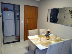 卡波布里奧的住宿－Apartamento Praia do Forte VIP，一间带桌子和冰箱的用餐室