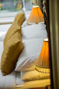 a bed with two pillows and two lamps on it at Brookfield B&B Guest House in Keswick