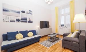a living room with a couch and a tv at Apartamenty Stary Rzeszów in Rzeszów