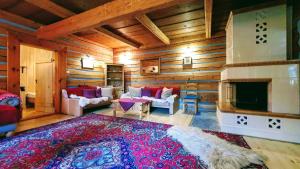 un soggiorno con pareti in legno e camino di Zdiar Holiday Cottage a Ždiar