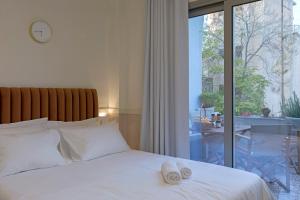 Posteľ alebo postele v izbe v ubytovaní Athenian Lofts