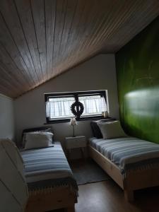 a small room with two beds and a window at Owczarnia in Szczyrk