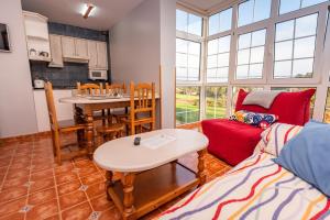 una sala de estar con un sofá y una mesa en Apartamentos Cudillero, en Cudillero