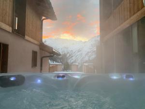 a bath tub with a view of a mountain at Chalet Beaufort in Saint-Martin-de-Belleville