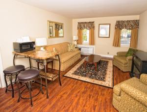 a living room with a couch and a table at Colonial Inn Seekonk in Seekonk